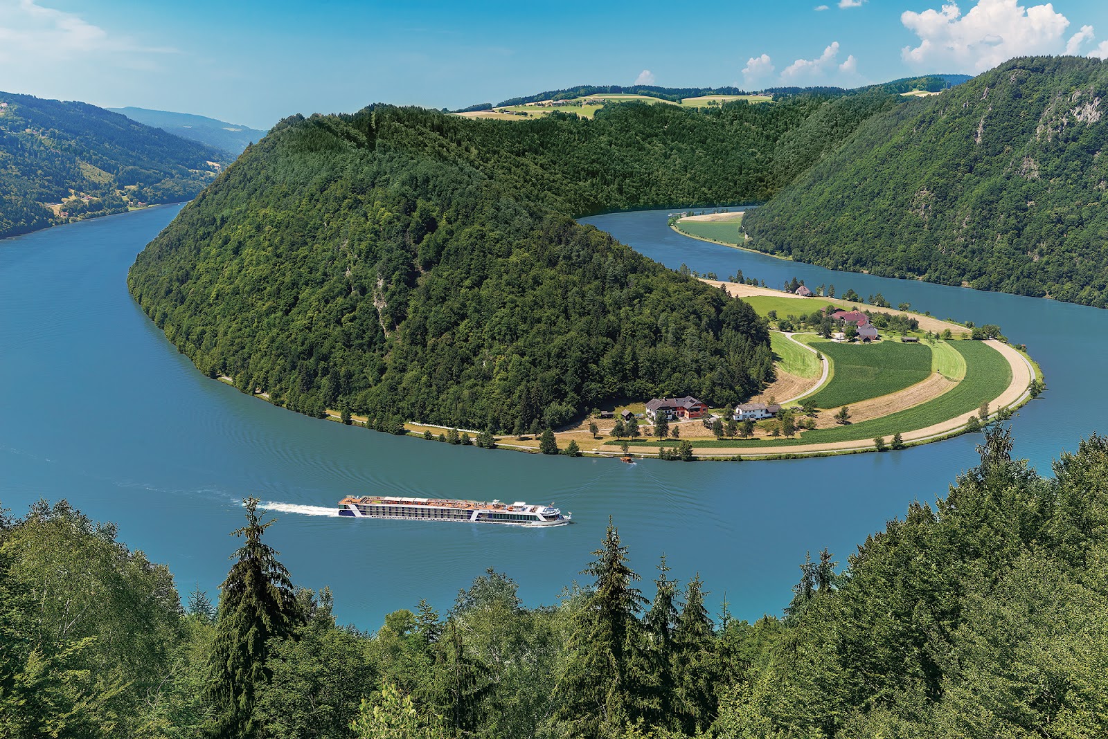 Aerial view of a river cruise ship rounding the Danube bend in the Wachau Valley