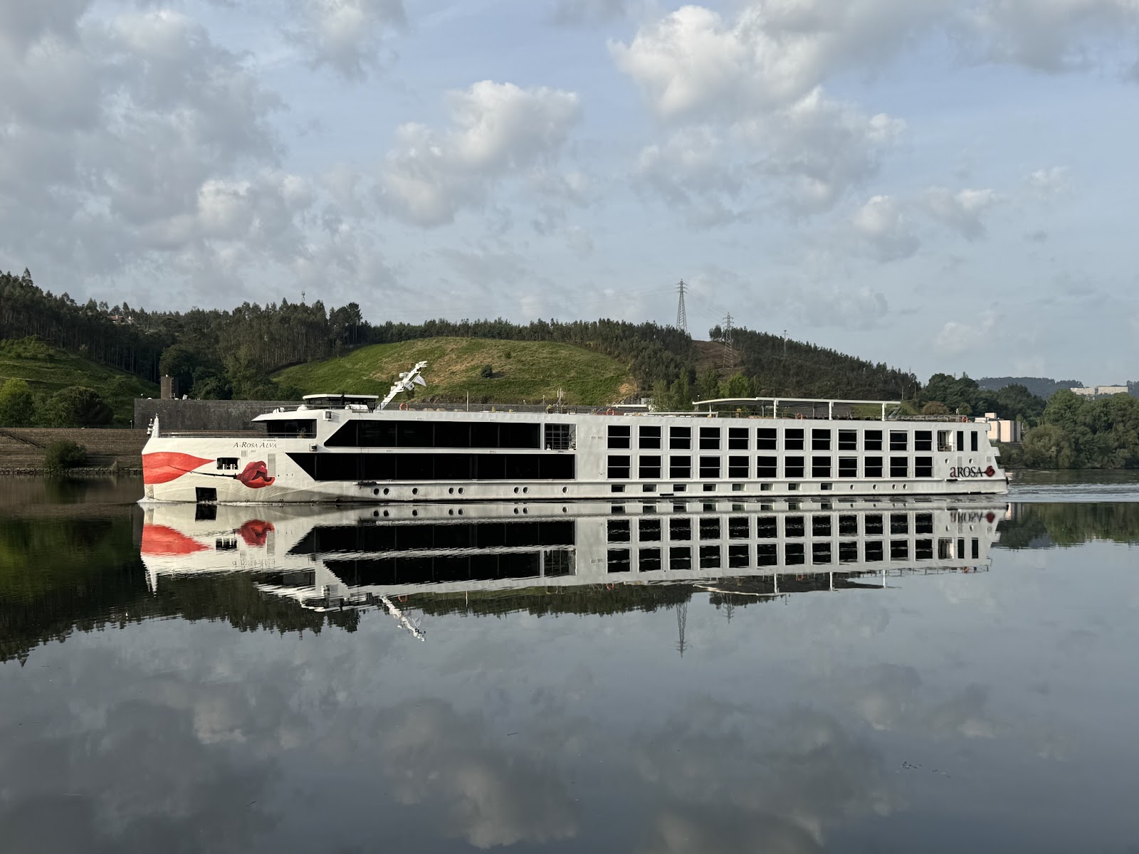 River cruise ship reflected on the calm Douro river in Portugal