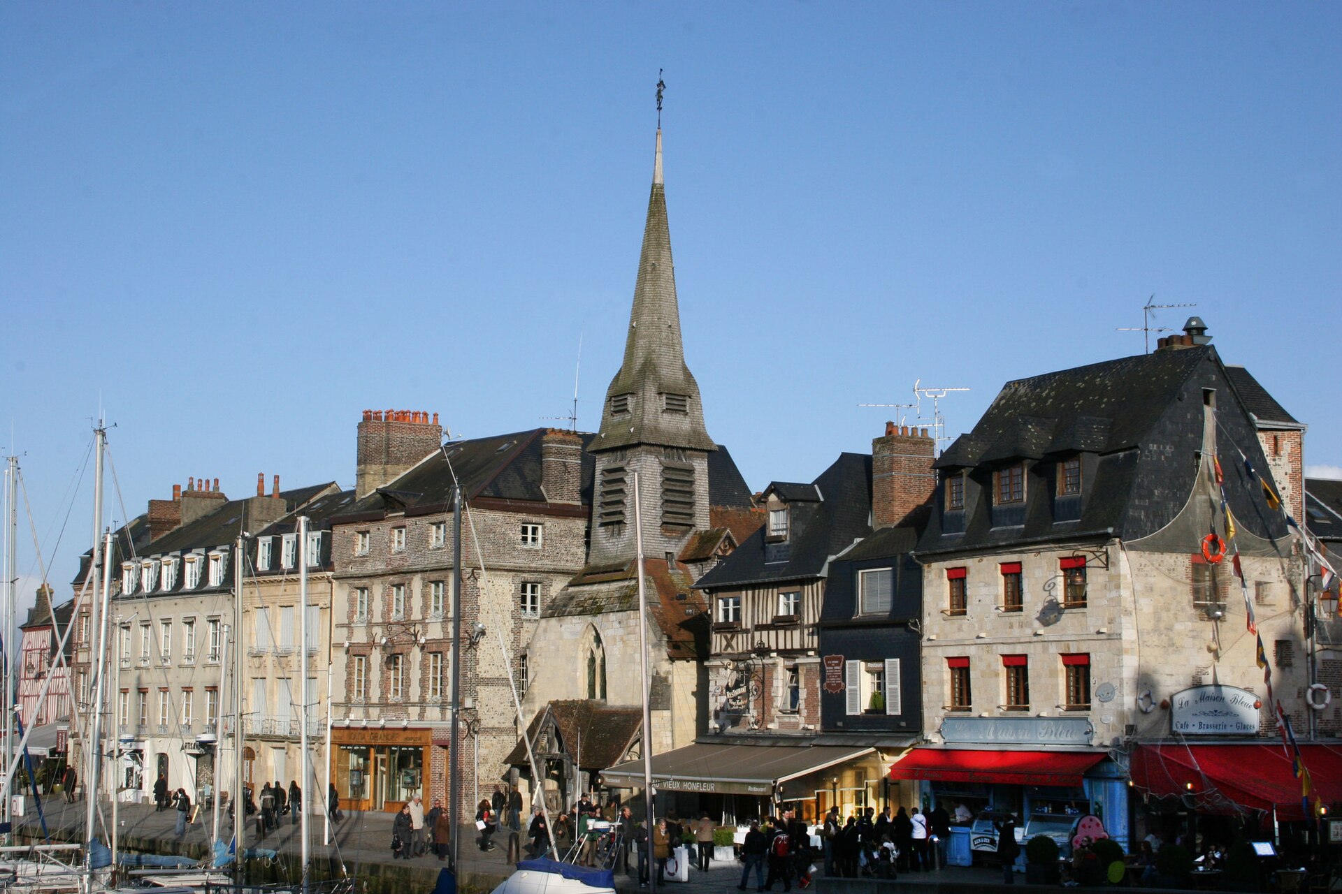 Tall reflected houses along the old harbour of Honfleur in Normandy